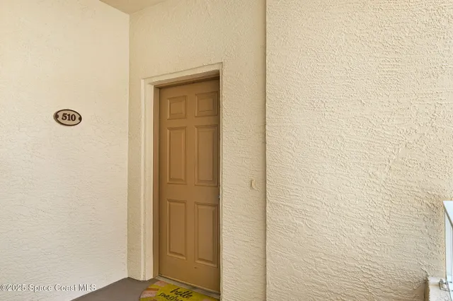 a kitchen with a refrigerator a stove a sink and a dining table with chairs