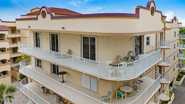 a view of a dining room with furniture and a chandelier fan