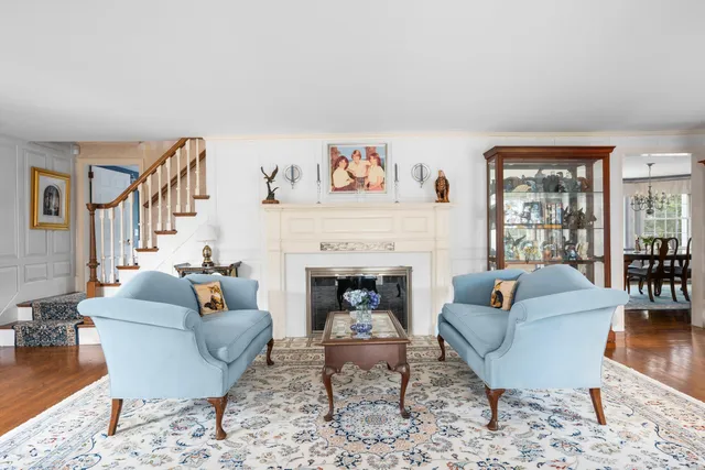 a living room with furniture a large window and a fireplace