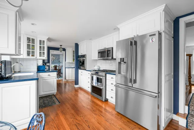 a spacious bedroom with a bed and wooden floor