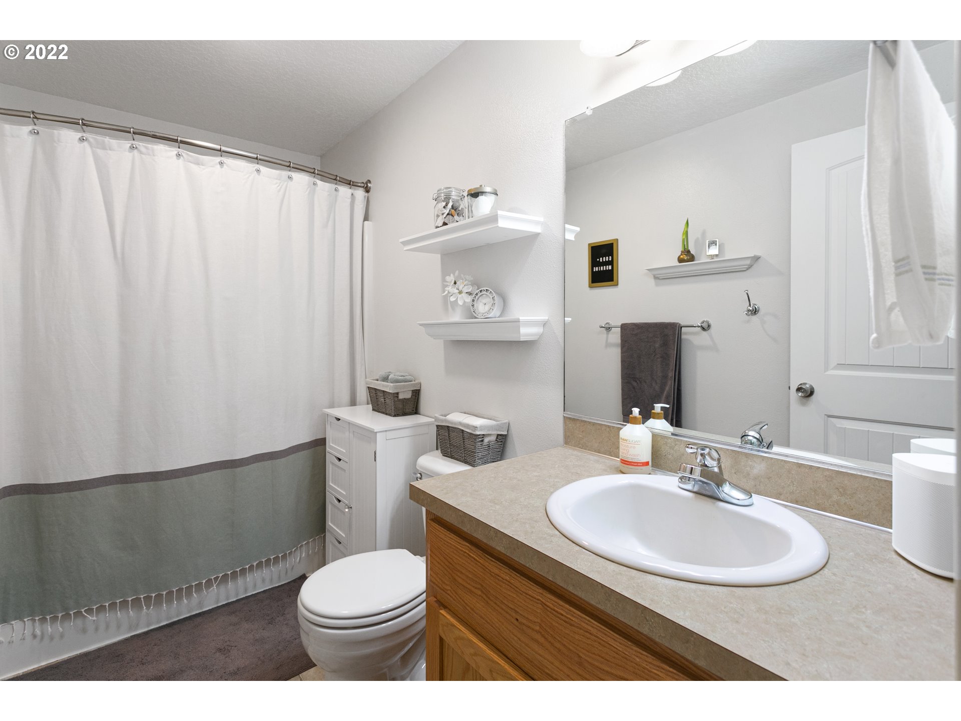601 West 1st Street, Unit 18 Newberg, OR 97132 - Photo 15 of 21 a bathroom with a sink toilet and a mirror