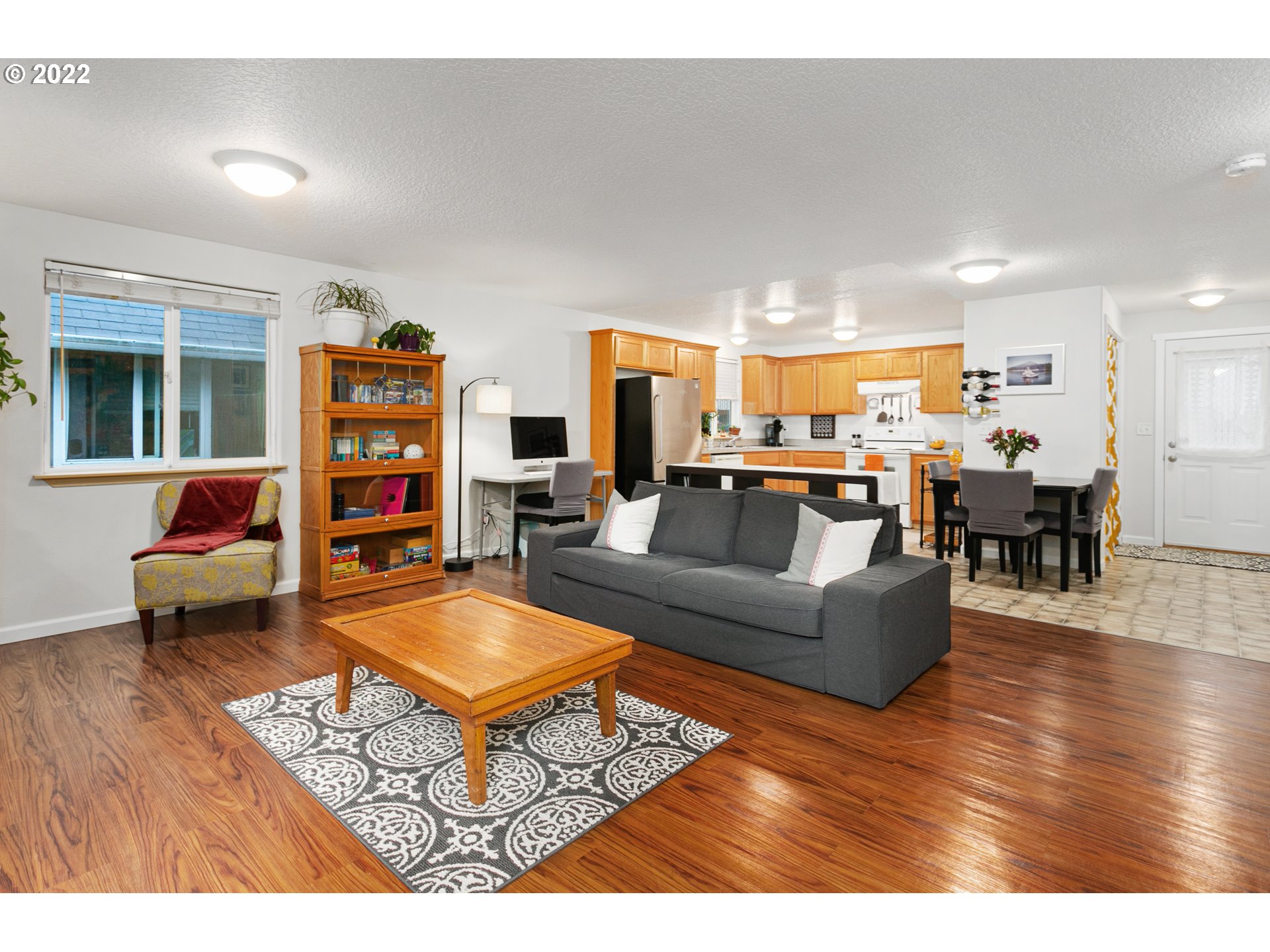 601 West 1st Street, Unit 18 Newberg, OR 97132 - Photo 6 of 21 a living room with furniture and a wooden floor