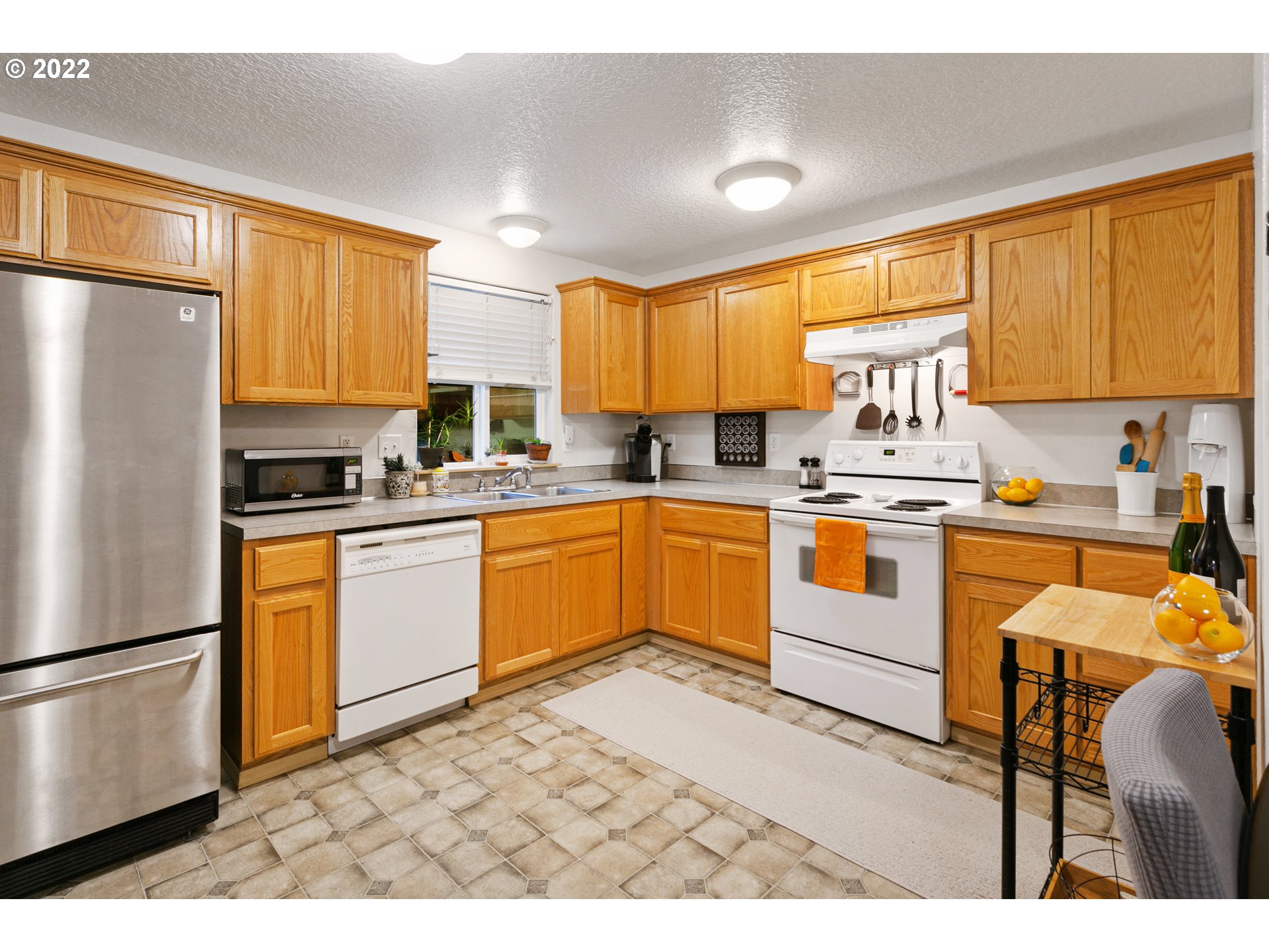 601 West 1st Street, Unit 18 Newberg, OR 97132 - Photo 10 of 21 a kitchen with stainless steel appliances granite countertop a refrigerator sink and cabinets