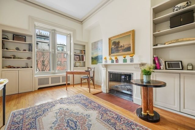 a living room with furniture a fireplace and windows