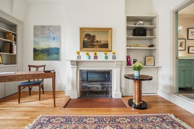 a living room with furniture a rug and a fireplace