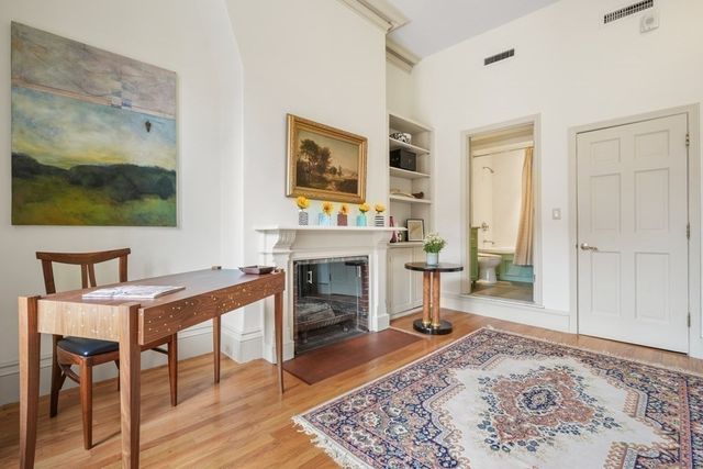 a view of a livingroom with furniture and a fireplace