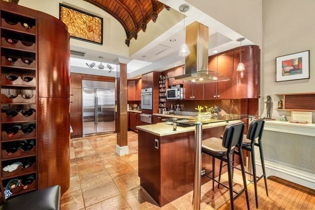 a kitchen with stainless steel appliances granite countertop a stove and a refrigerator