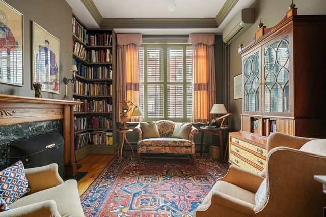 a living room with furniture and a floor to ceiling window