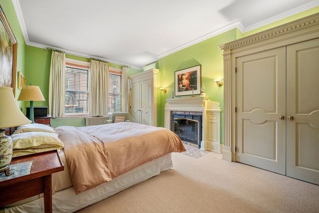 a bedroom with a bed and a fireplace