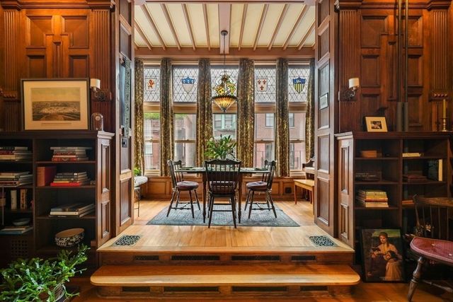 a living room filled with furniture and a potted plant