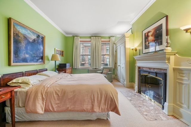 a bedroom with a bed and a fireplace