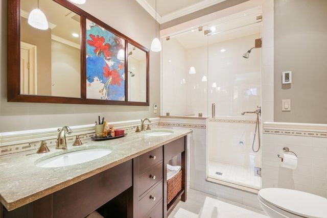 a bathroom with a granite countertop sink mirror toilet and bathtub