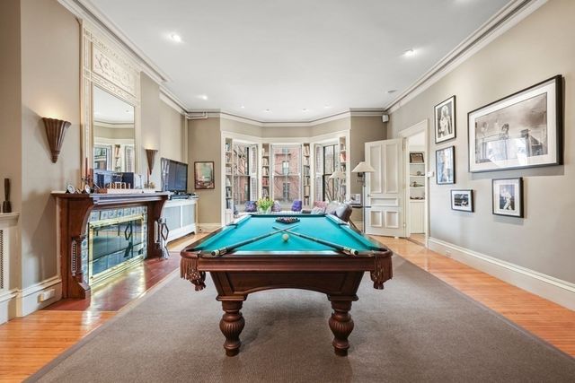a living room with kitchen island furniture and a potted plant