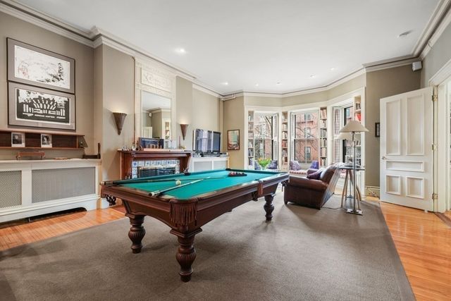 a living room with furniture a table and a large window
