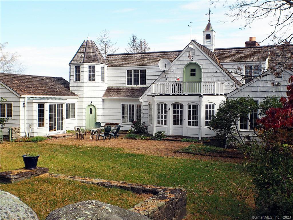 a front view of a house with swimming pool having outdoor seating