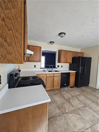 a kitchen with stainless steel appliances a sink a stove and a refrigerator