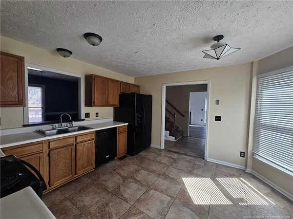 a large kitchen with kitchen island a sink stainless steel appliances and cabinets