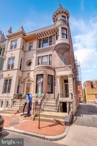 a front view of a residential apartment building with a yard