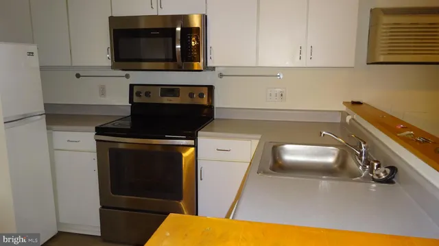 a kitchen with a stove and a microwave