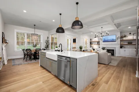 a kitchen with a sink stove and cabinets