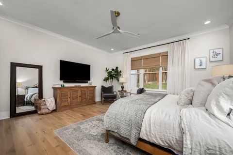 a bedroom with a bed and a table chair