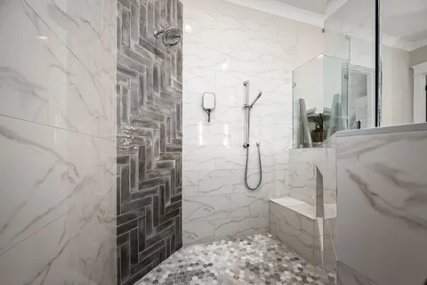 a bathroom with a double vanity sink mirror and shower