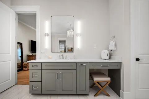 a bathroom with a double vanity sink mirror and bathtub