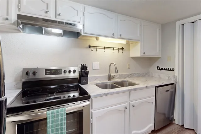 a kitchen with a stove and a sink