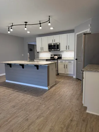 a view of a livingroom with wooden floor