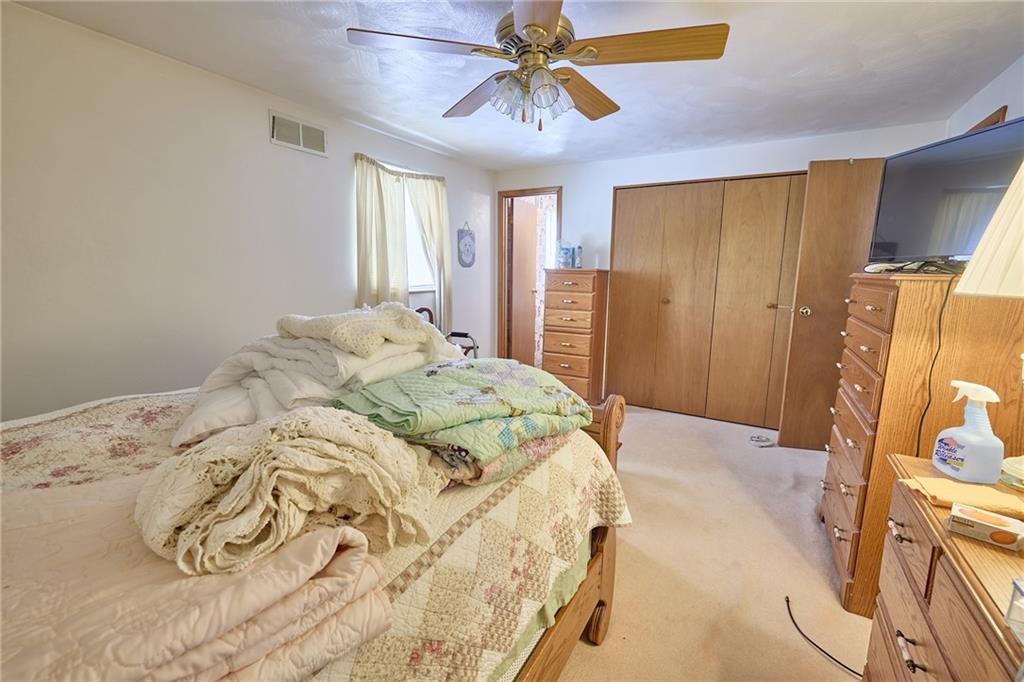 151 Stone Quarry Road Aliquippa, PA 15001 - Photo 12 of 26 a bedroom with a bed and a chandelier