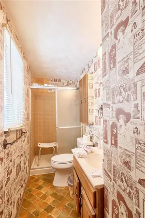 a bathroom with a sink toilet and shower