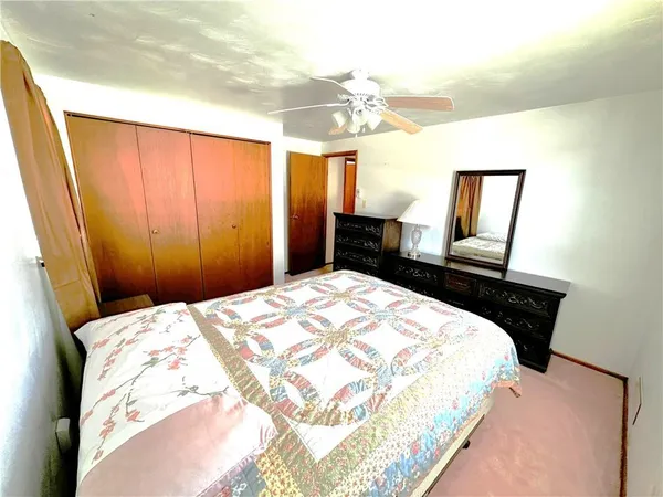 a bedroom with a bed and a mirror