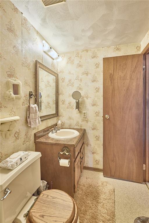 151 Stone Quarry Road Aliquippa, PA 15001 - Photo 20 of 26 a bathroom with a granite countertop toilet a sink and a mirror