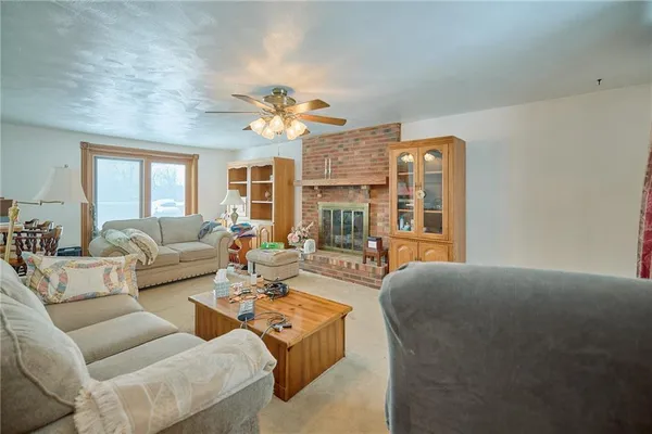 a living room with fireplace furniture and a chandelier