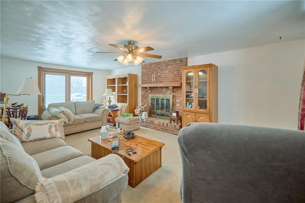 151 Stone Quarry Road Aliquippa, PA 15001 - Photo 7 of 26 a living room with fireplace furniture and a chandelier
