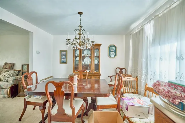 a view of a dining room with furniture and chandelier