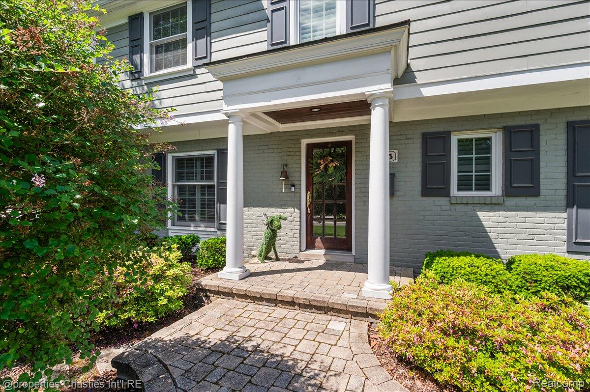 135 Clifton Road Bloomfield Hills, MI 48301 - Photo 3 of 77 Front entry with a portico featuring two white columns and a paneled wood door with glass inserts
