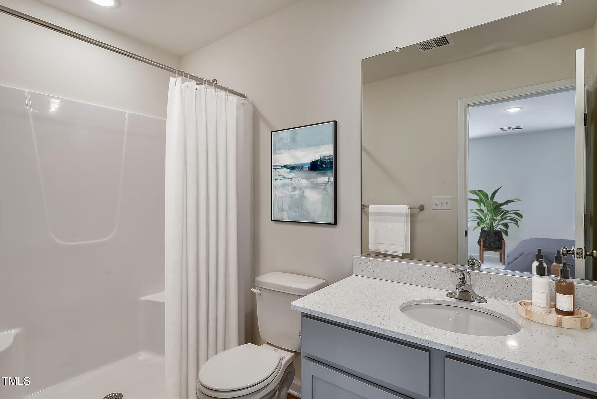 2700 Barrington Drive Raleigh, NC 27610 - Photo 9 of 27 a bathroom with a sink toilet and vanity