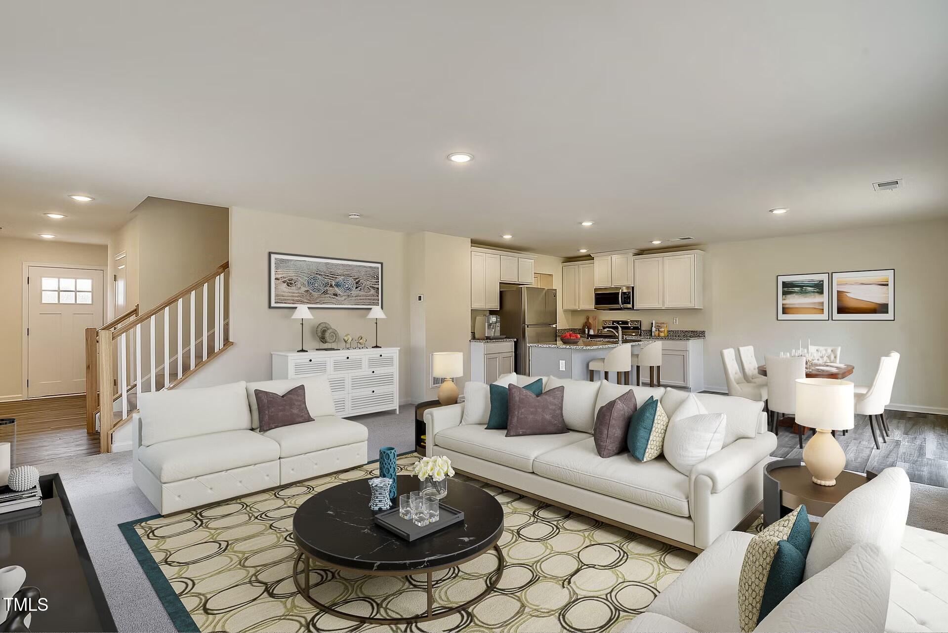 2700 Barrington Drive Raleigh, NC 27610 - Photo 18 of 27 a living room with furniture and a dining table with kitchen view
