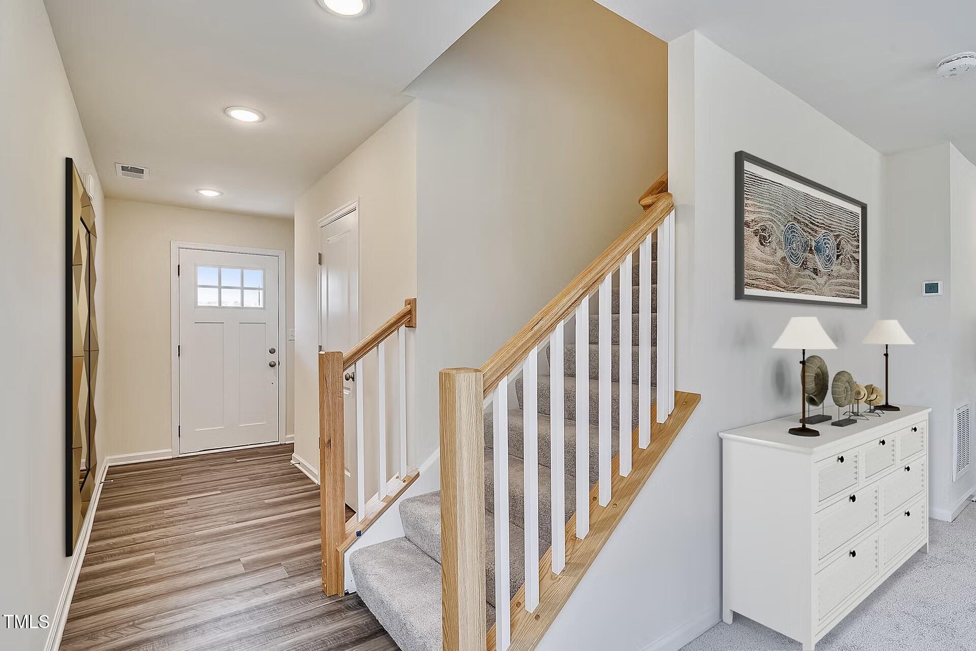 2700 Barrington Drive Raleigh, NC 27610 - Photo 2 of 27 a view of hallway with stairs and wooden floor