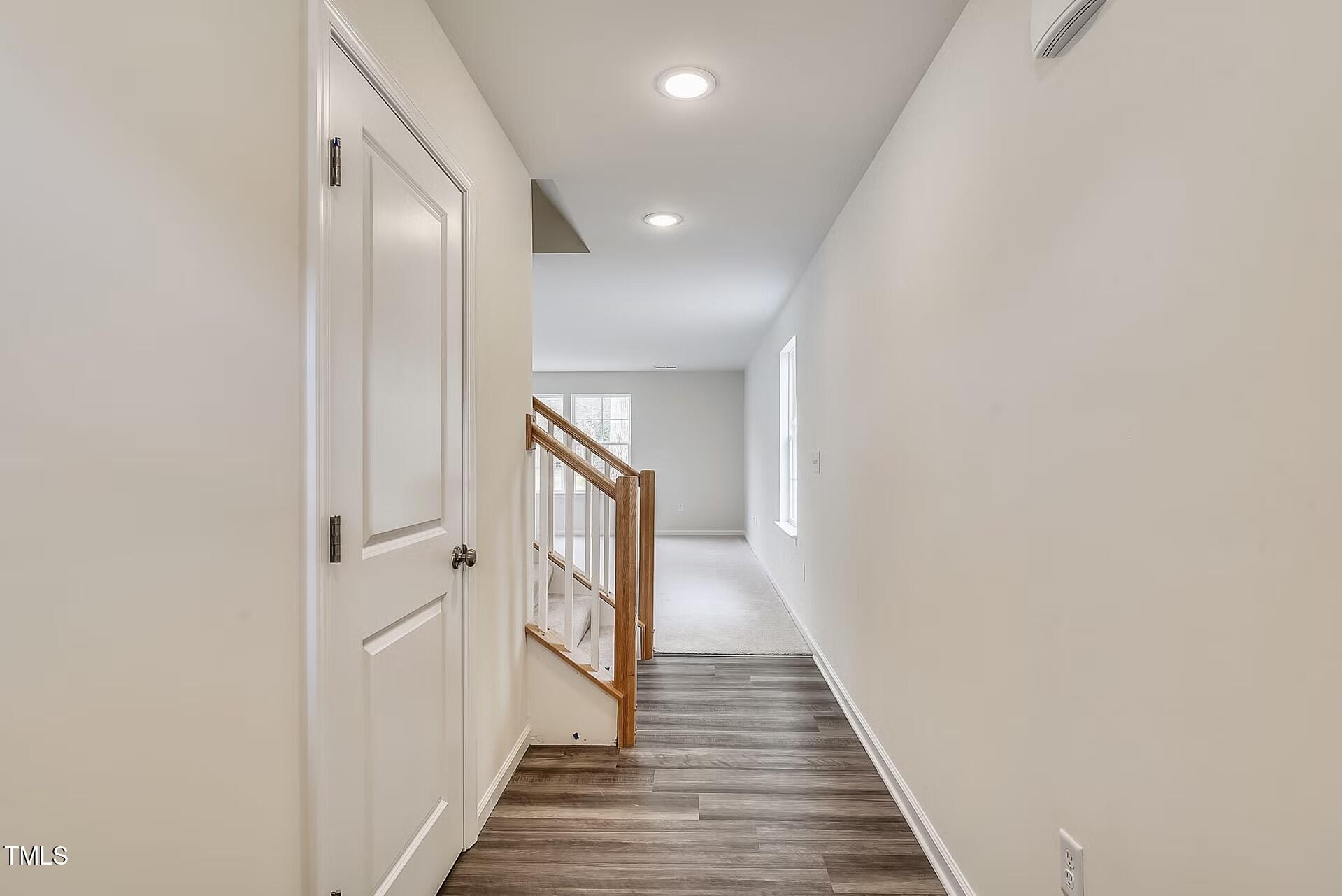 2700 Barrington Drive Raleigh, NC 27610 - Photo 3 of 27 a view of a hallway with wooden floor and staircase