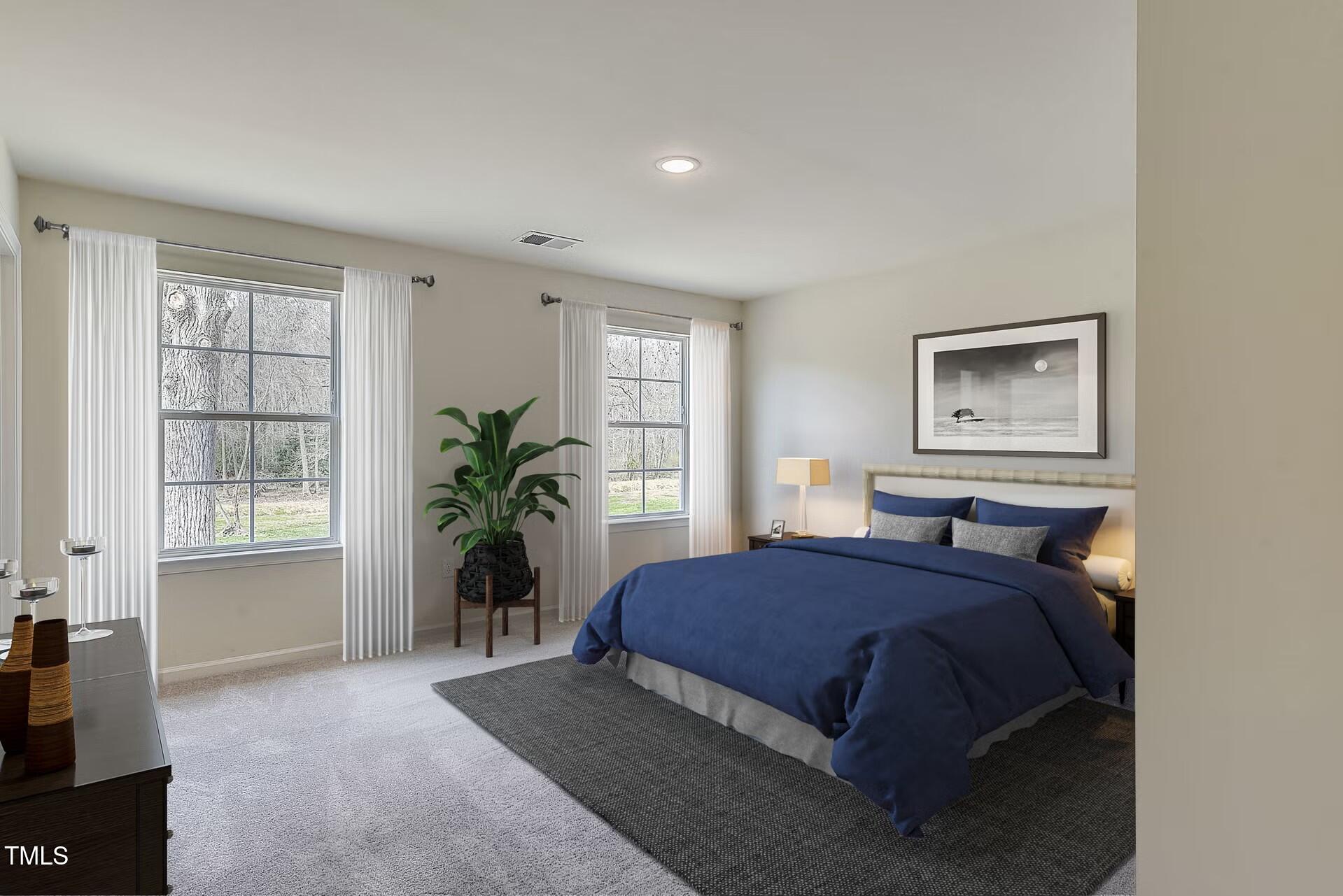 2700 Barrington Drive Raleigh, NC 27610 - Photo 7 of 27 a bedroom with a large bed and a window