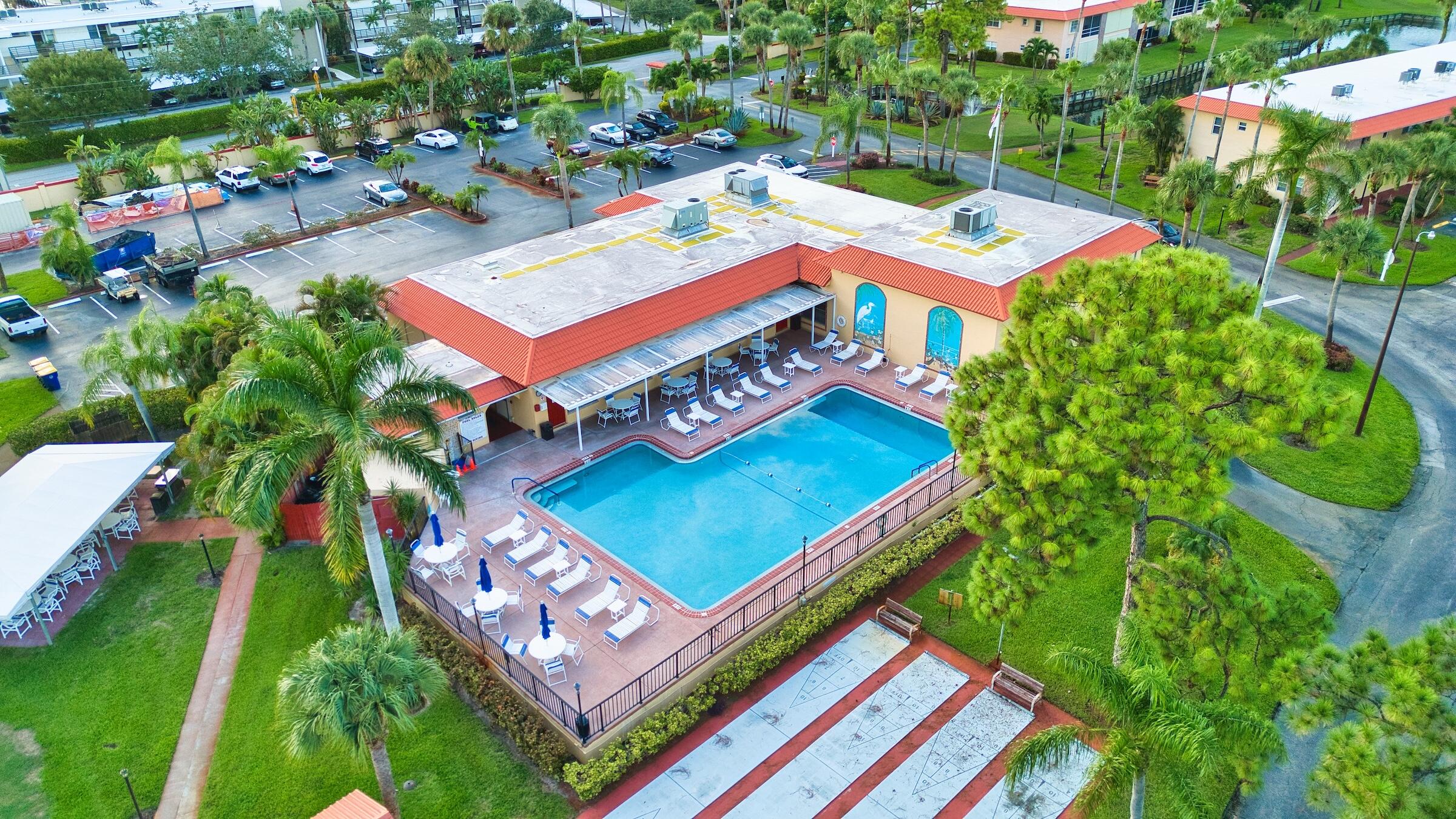 1911 Southwest Palm City Road, Unit J Stuart, FL 34994 - Photo 13 of 42 an aerial view of a tennis ground with large trees