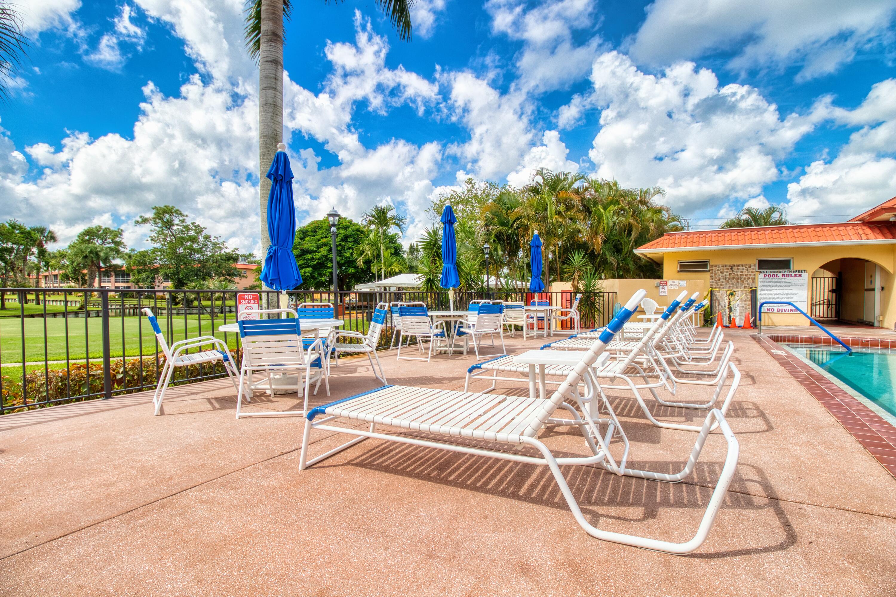 1911 Southwest Palm City Road, Unit J Stuart, FL 34994 - Photo 17 of 42 a view of a patio with swimming pool