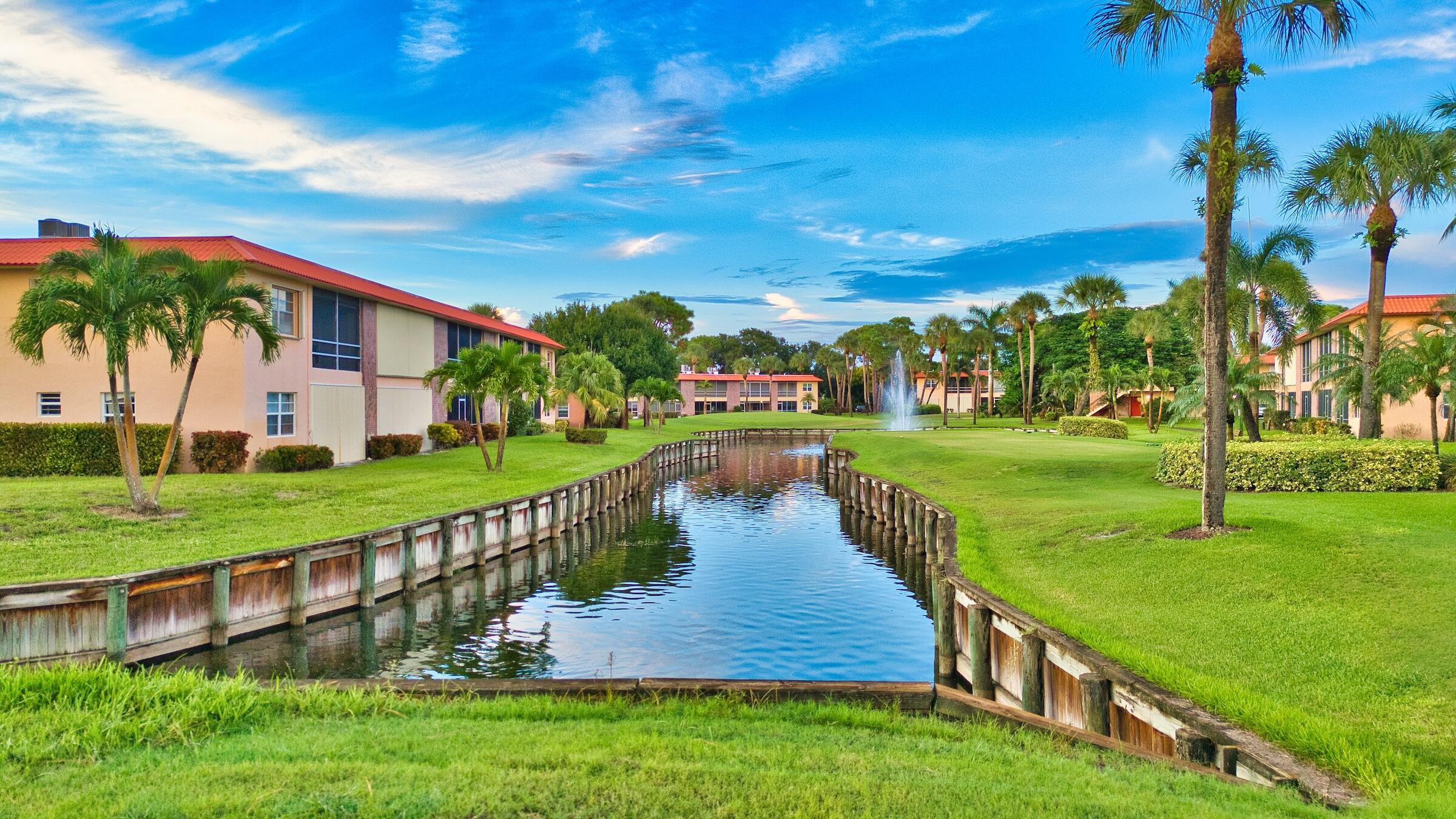 1911 Southwest Palm City Road, Unit J Stuart, FL 34994 - Photo 27 of 42 a view of a house with a yard and potted plants