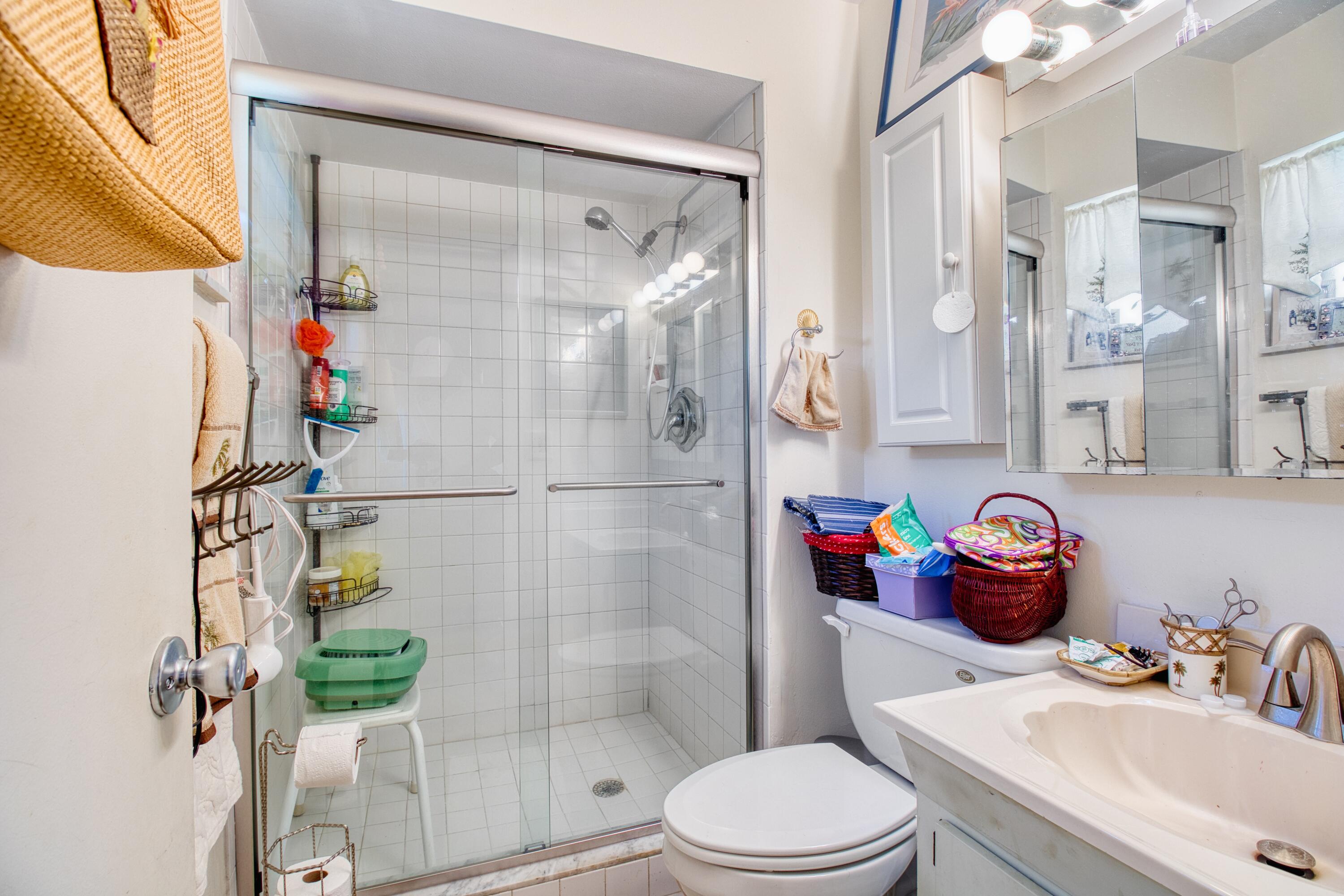 1911 Southwest Palm City Road, Unit J Stuart, FL 34994 - Photo 9 of 42 a bathroom with a sink toilet and shower