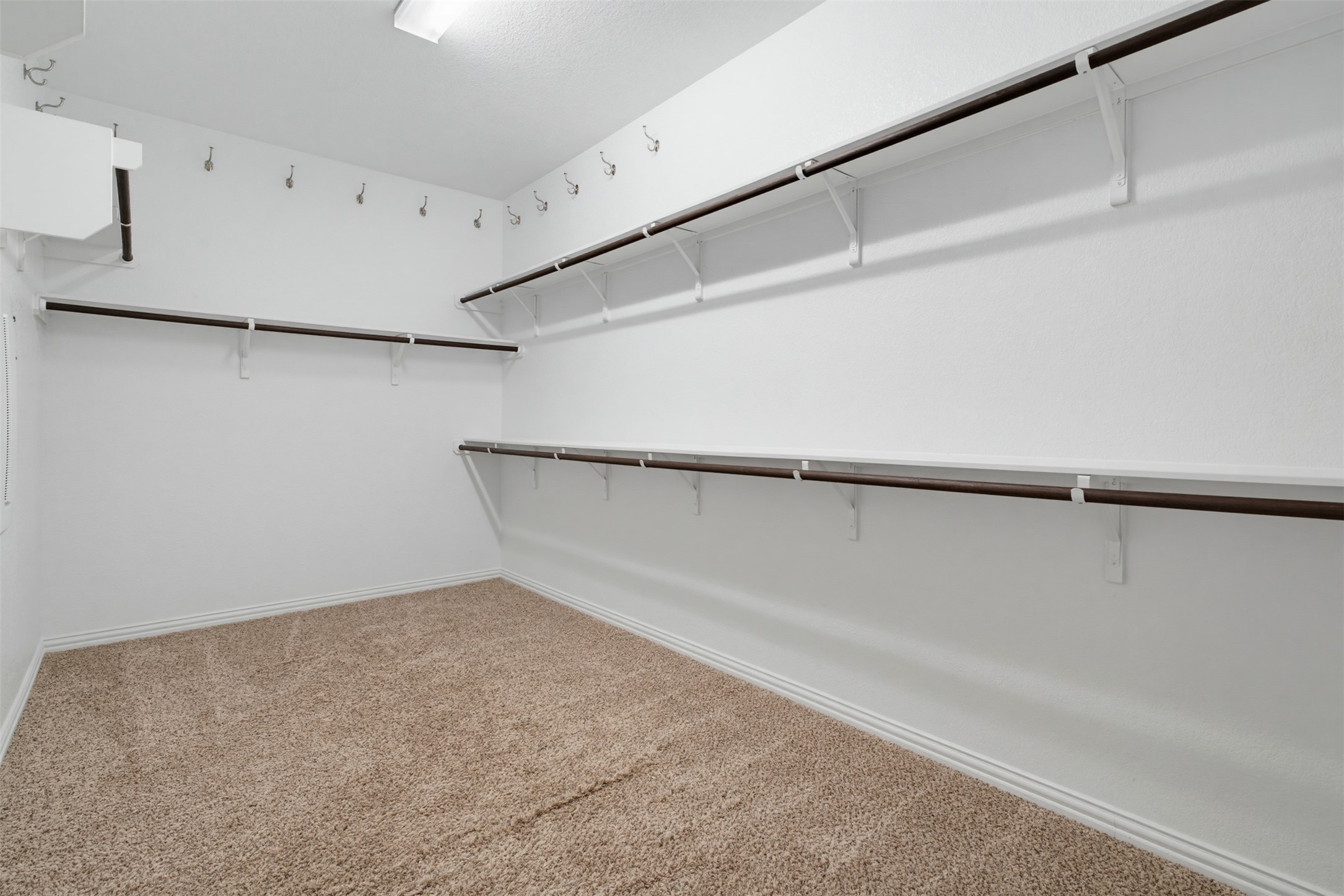 12613 Twisted Root Drive Manchaca, TX 78652 - Photo 15 of 33 Functional shelving and hanging space offer plentiful storage within this organized walk-in closet.