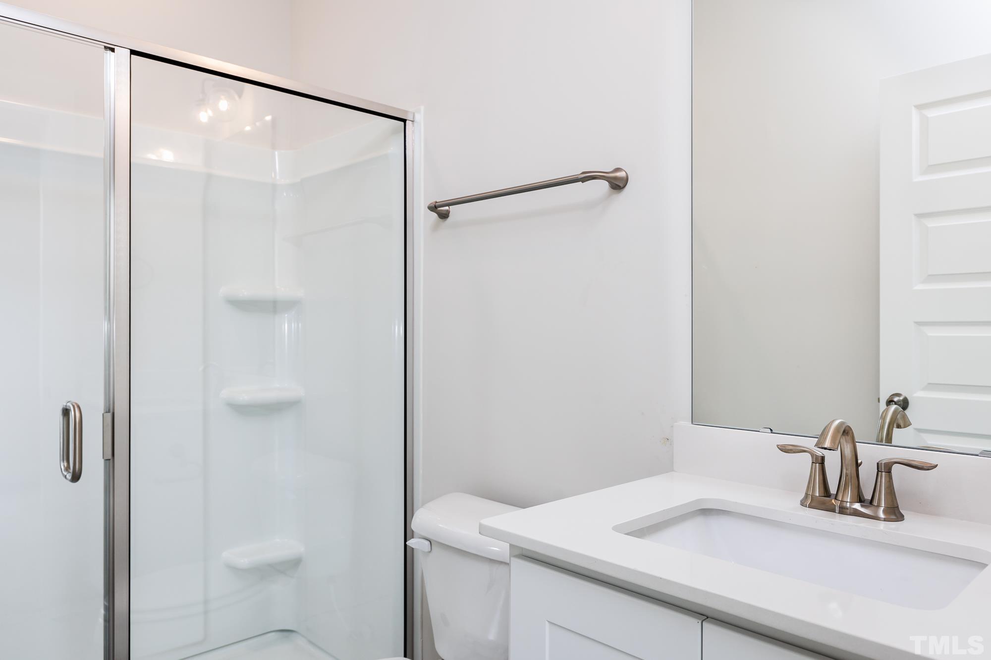 8111 Diversity Way Raleigh, NC 27613 - Photo 4 of 26 a bathroom with a sink and a mirror
