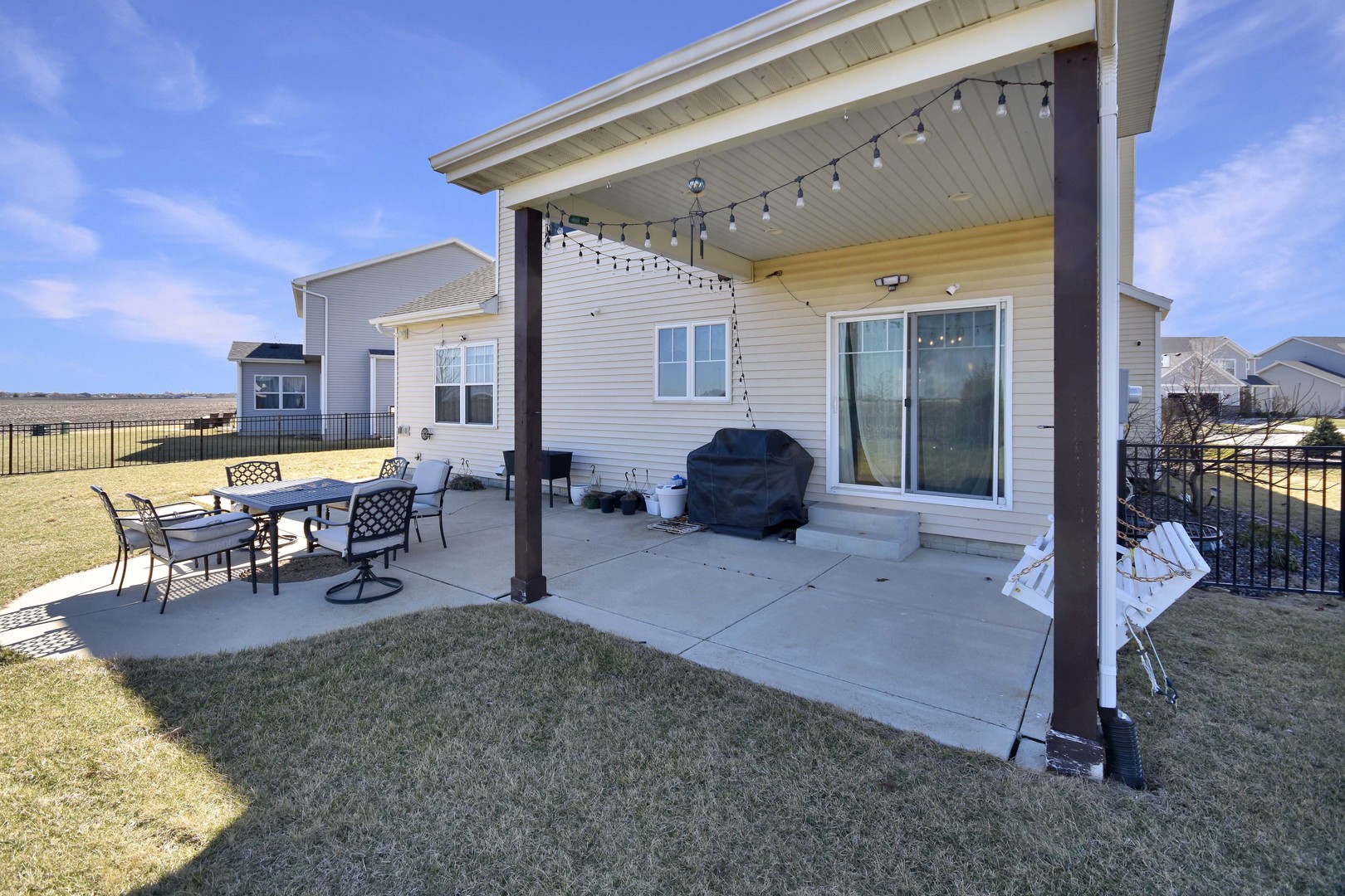 3638 Napa Lane Normal, IL 61761 - Photo 47 of 53 a view of a patio with dining table and chairs under an umbrella with a patio
