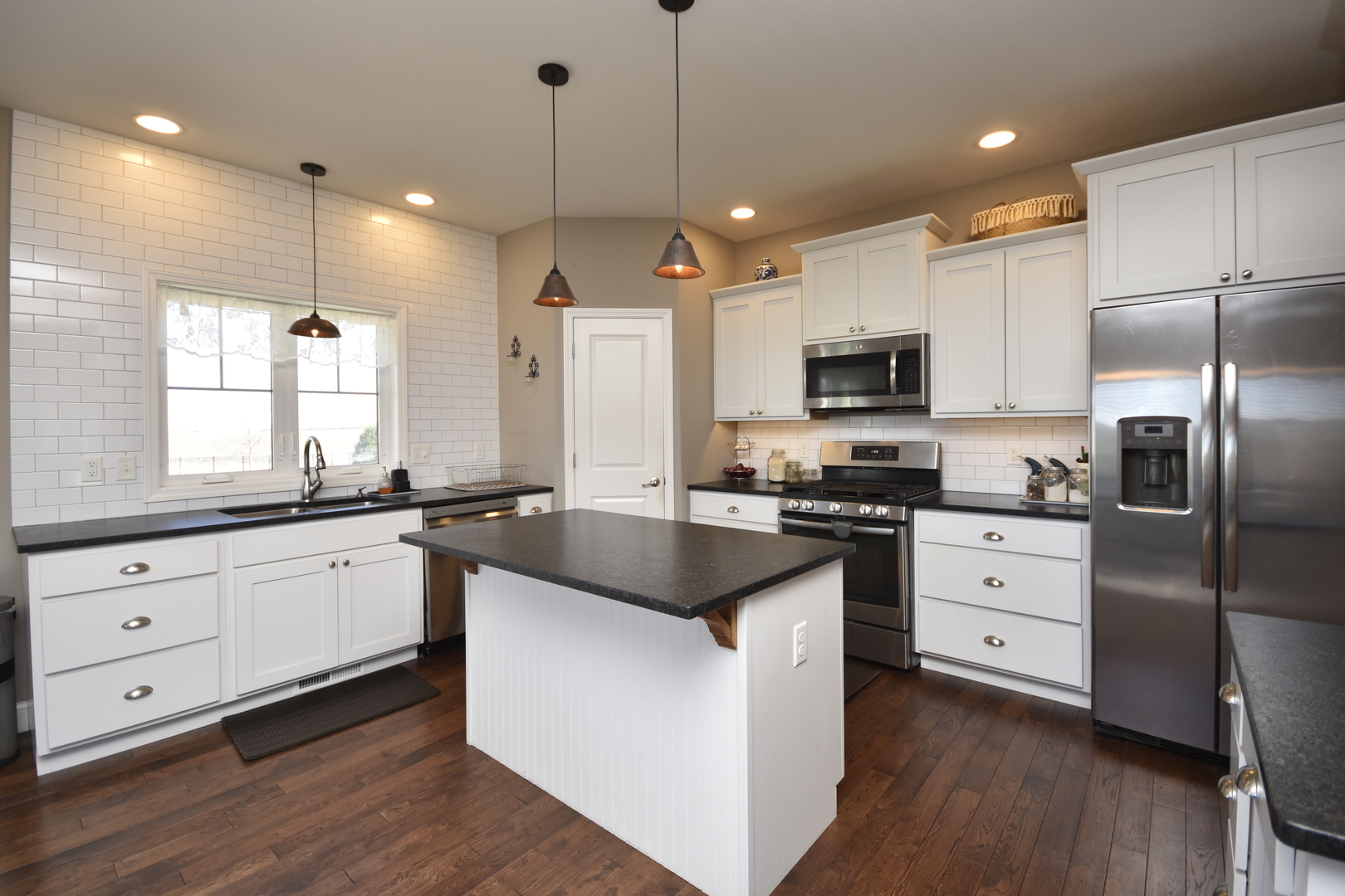 3638 Napa Lane Normal, IL 61761 - Photo 10 of 53 a kitchen with granite countertop a refrigerator stove a sink and white cabinets